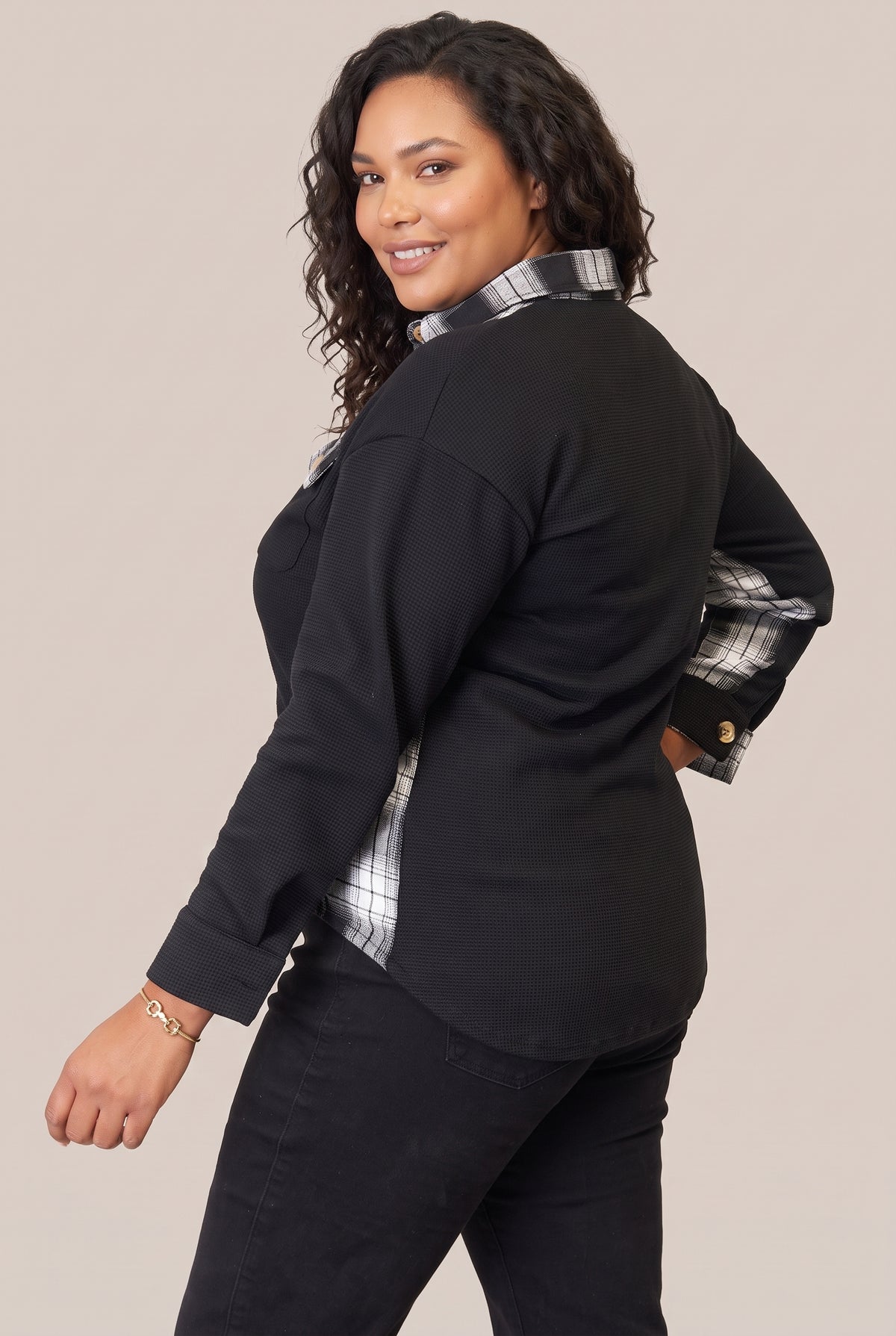 Back and side view of the black jacket with plaid side panel
