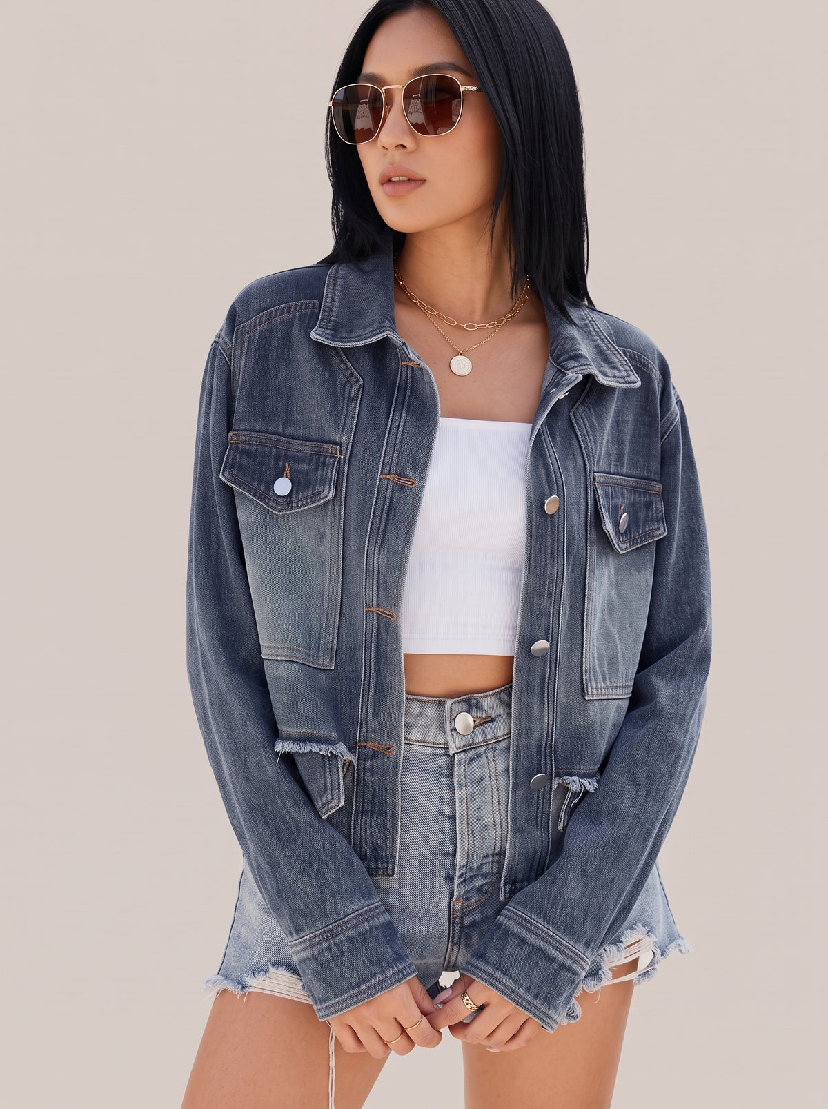Navy button up denim jacket, front three-quarter view with button cuffs