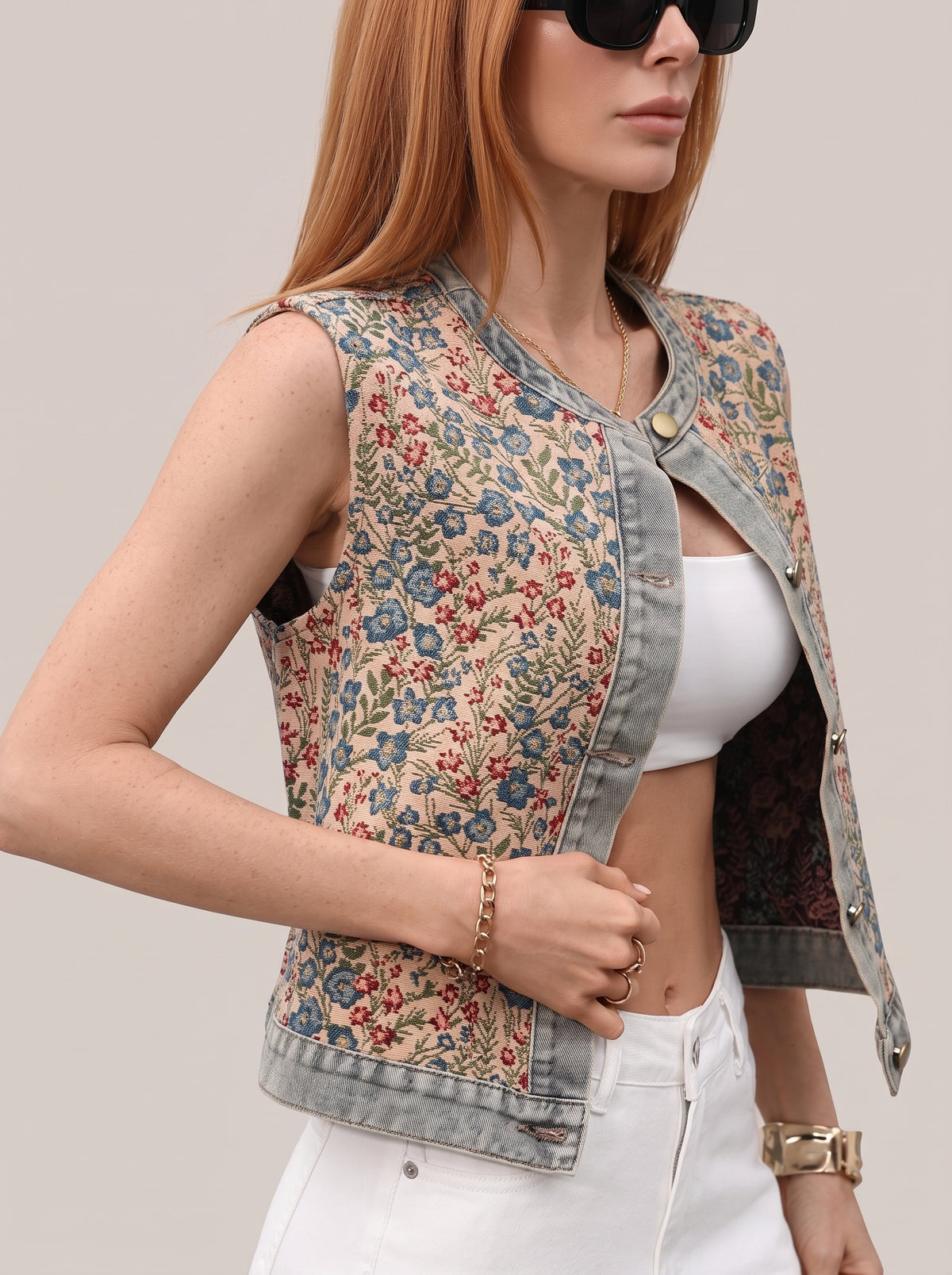 Floral vest top worn open, side view showing the denim trim