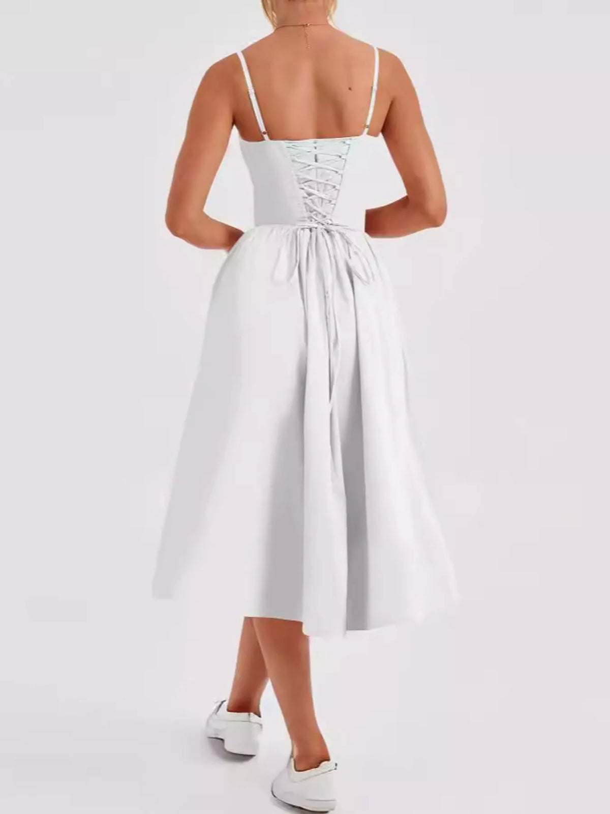 Back view of the White midi dress showing the criss-cross lace-up back and long ties
