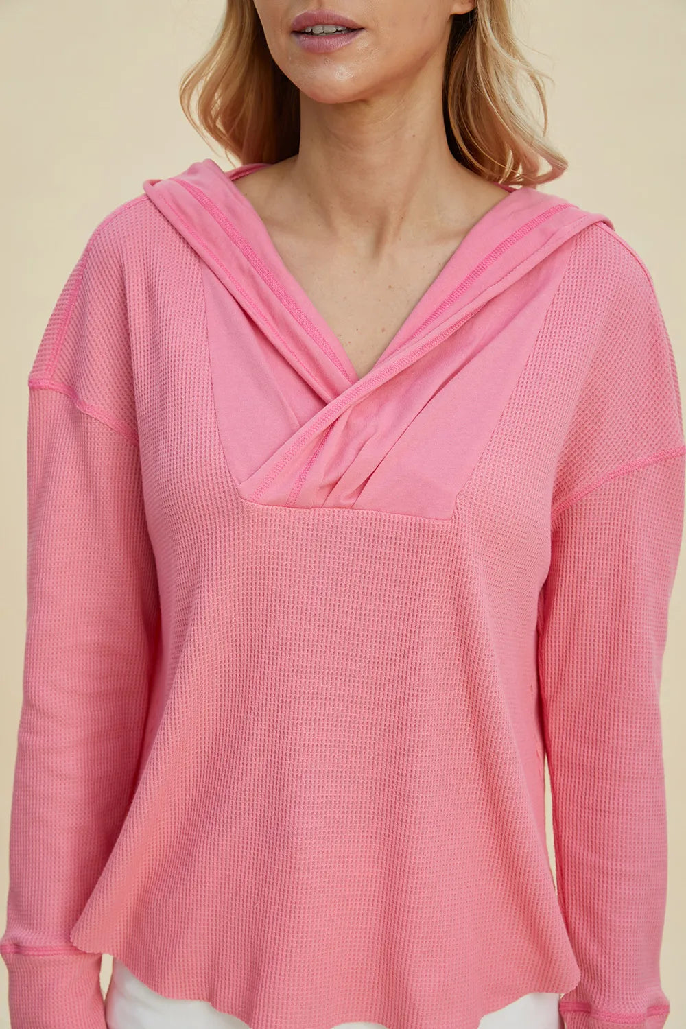 Close-up of the pink hoodie crossover neckline and waffle texture