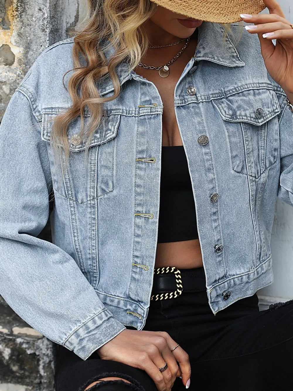Close view of the light wash denim jacket collar, buttons and flap chest pockets
