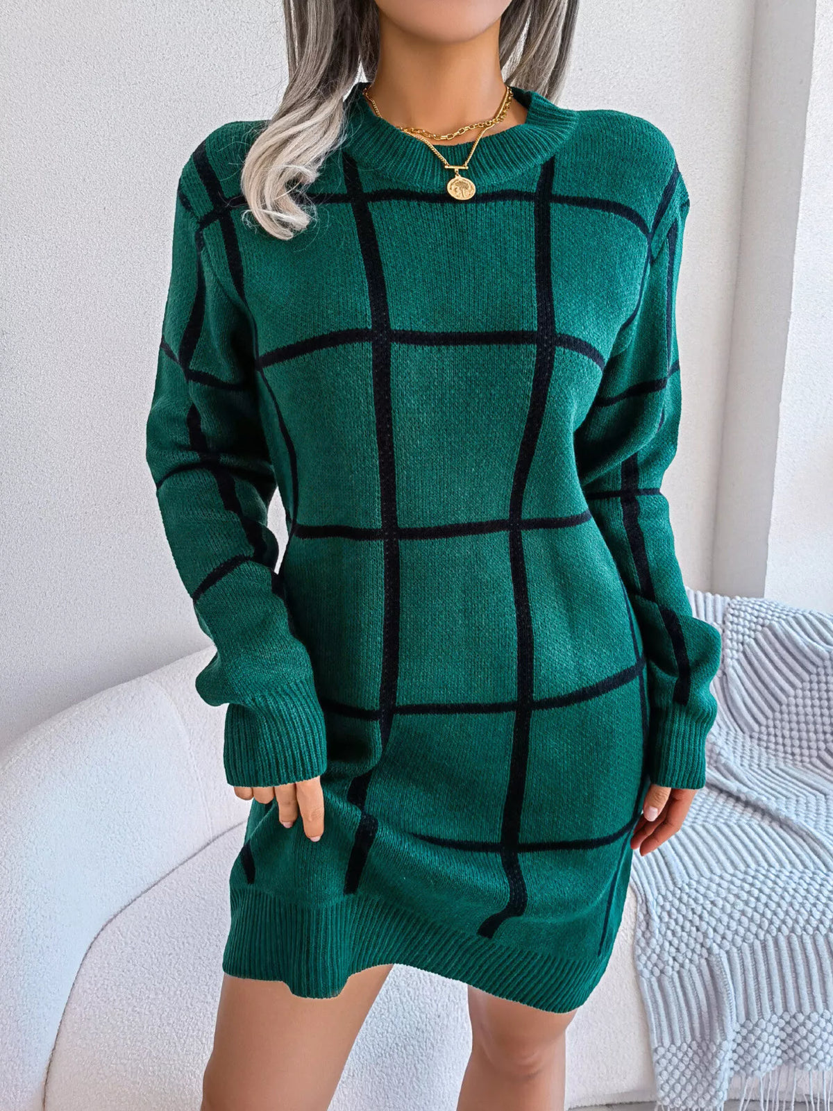 Black Forest deep green long sleeve knit mini sweater dress with a black windowpane grid pattern and ribbed cuffs and hem, front view