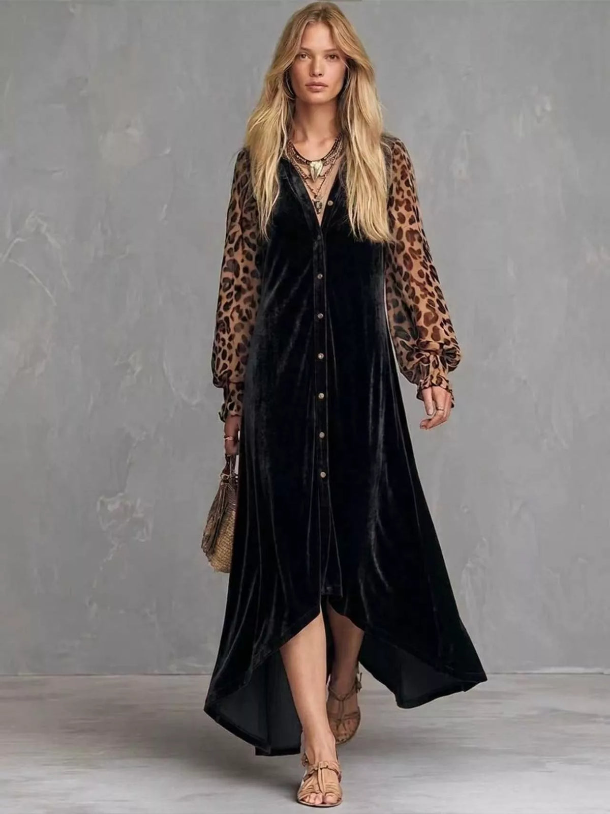 Woman wearing a black velvet button-front maxi dress with leopard print sleeves, full-length front view