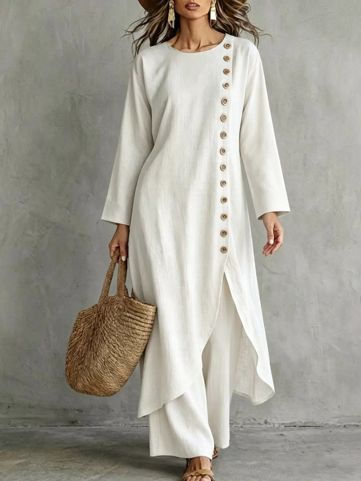 White longline top with a row of buttons down one side and matching pants, front view
