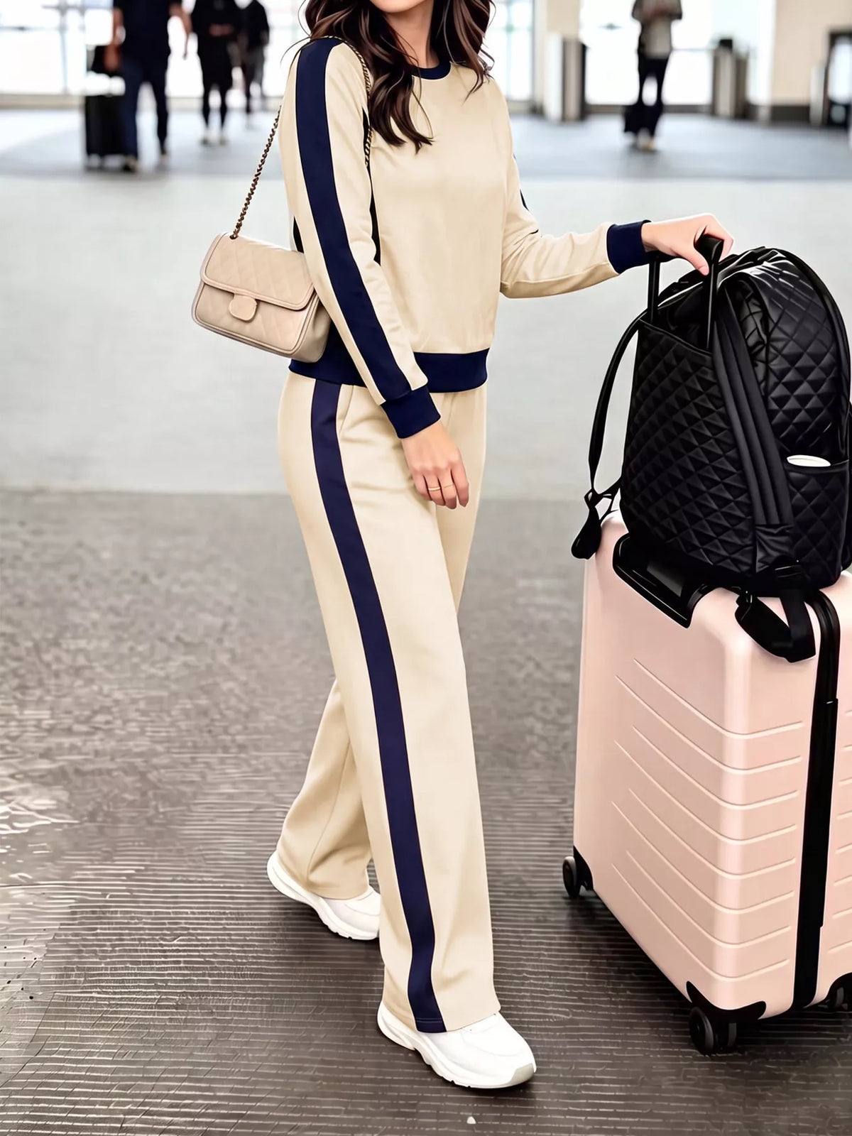 Side view of the Apricot top and pants set showing the navy stripe down the outer sleeve and the outer leg