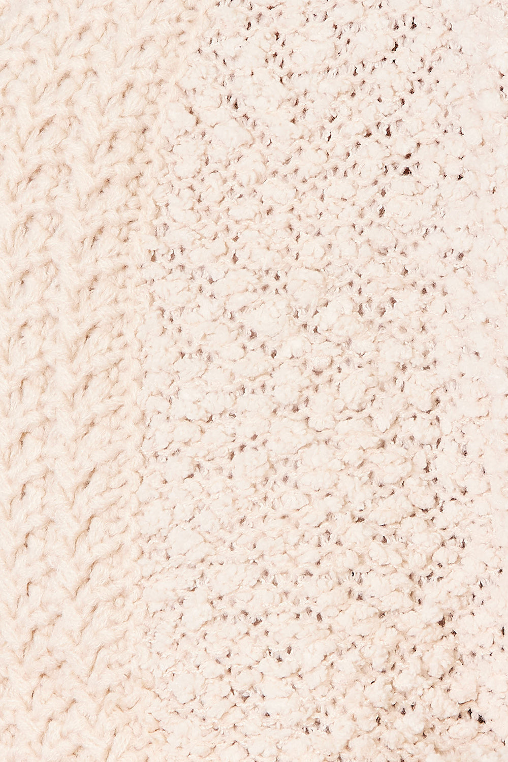 Close-up of the cream textured knit and ribbed hem