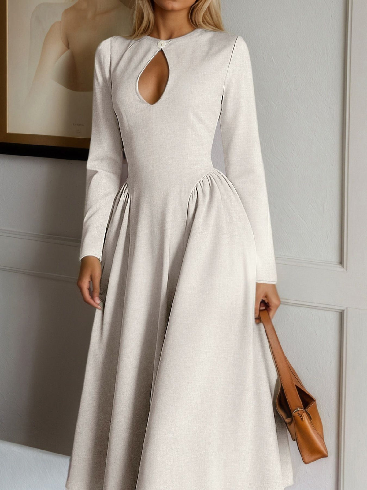 Close view of beige midi dress bodice with keyhole cutout, neckline button and gathered hips
