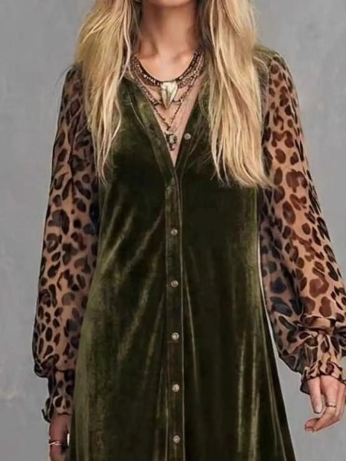 Close-up of the buttoned bodice and leopard print sleeves of an army green velvet maxi dress