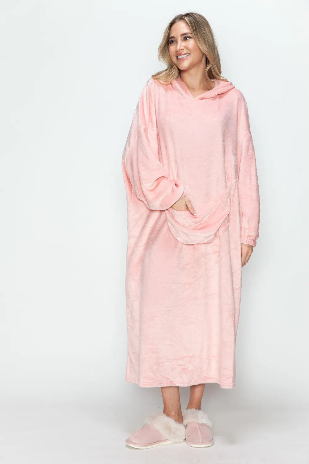 Dusty pink hooded lounge dress, three-quarter front, hand in pocket