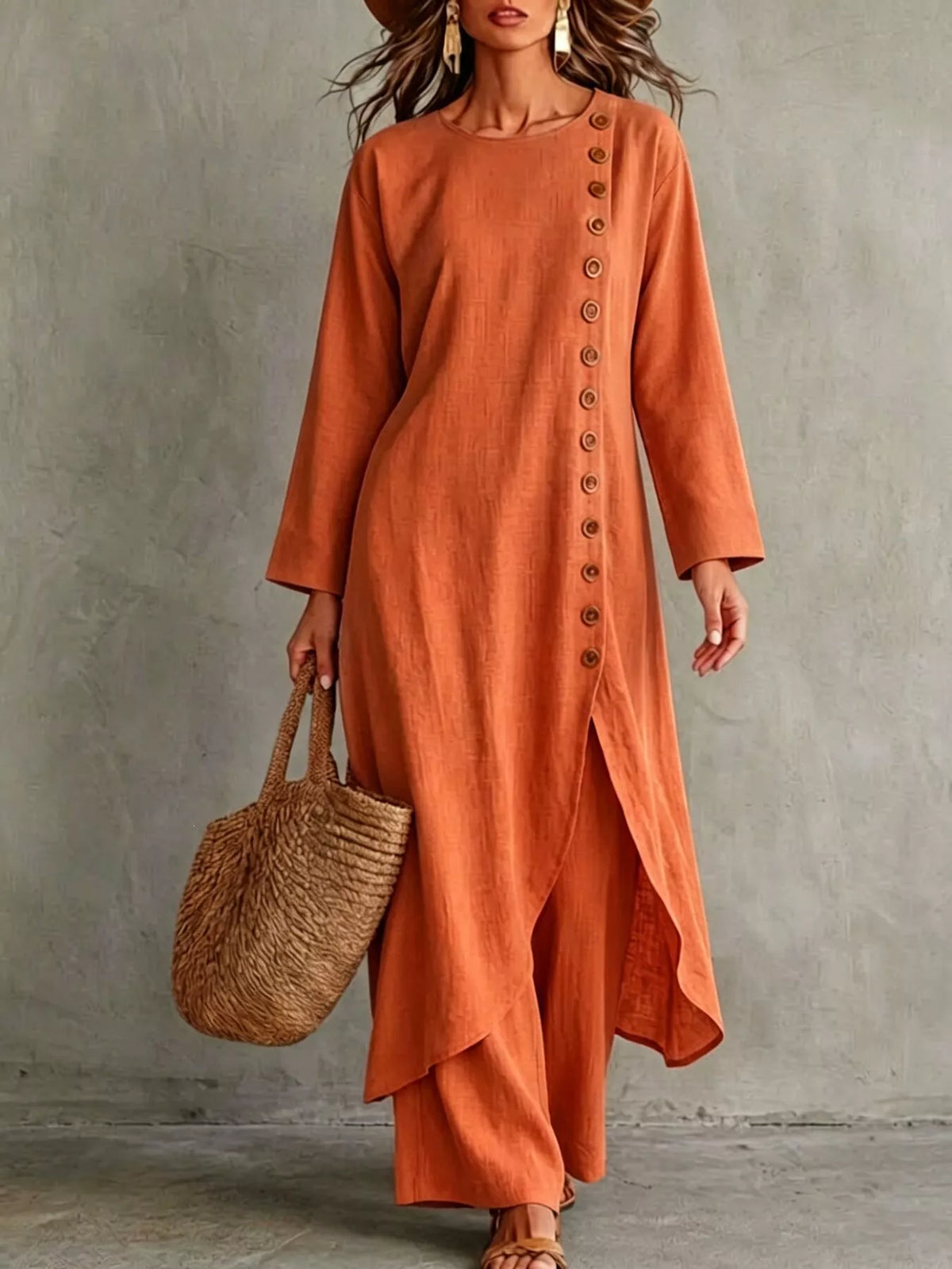 Orange-red longline top with a row of buttons down one side and matching pants, front view
