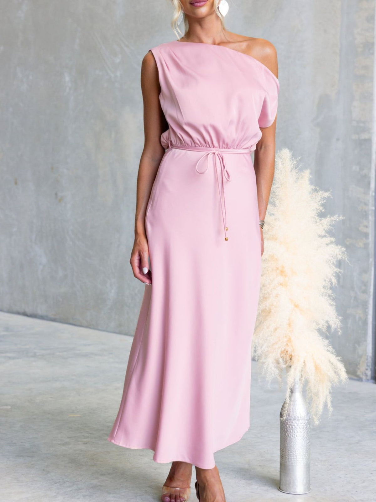 Pink one-shoulder maxi dress, front view with tie waist detail