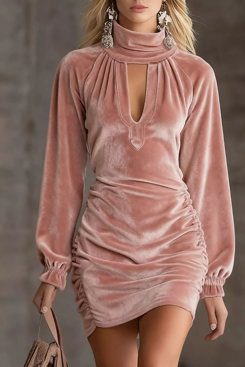 Dusty pink velvet mini dress with a high neck, front keyhole cutout, gathered yoke, long sleeves with gathered cuffs and ruched sides, front view