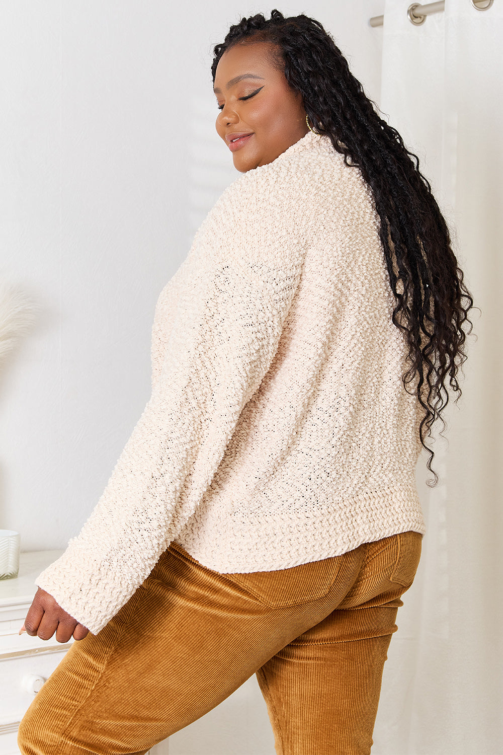 Plus-size model, cardigan side view with relaxed long sleeves
