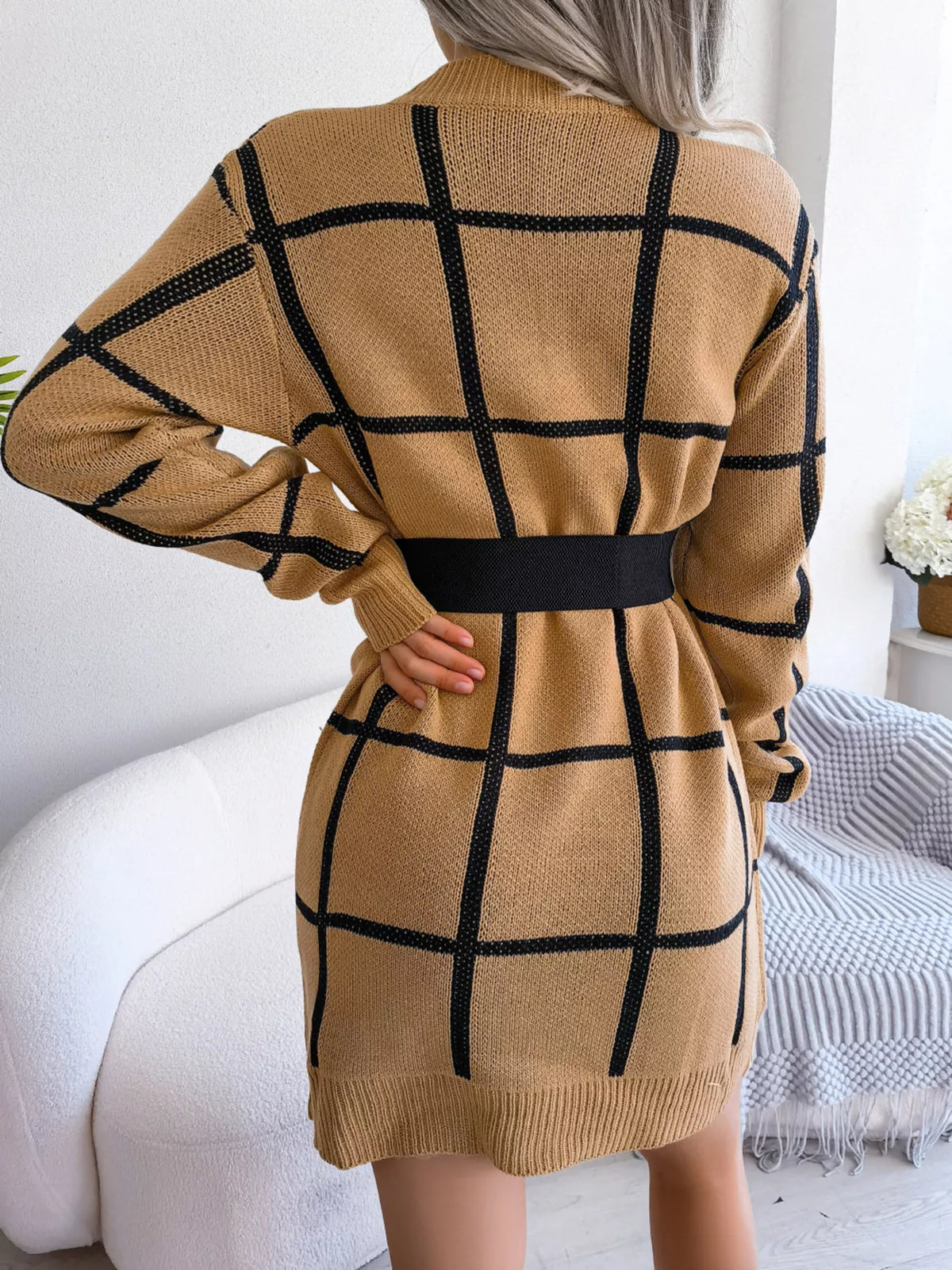 Back view of the Camel knit sweater dress with a black windowpane grid pattern, styled with a black belt (belt not included)