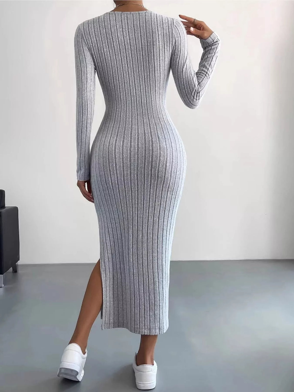 Back view of the Light Gray ribbed knit long-sleeve midi dress with the side slit