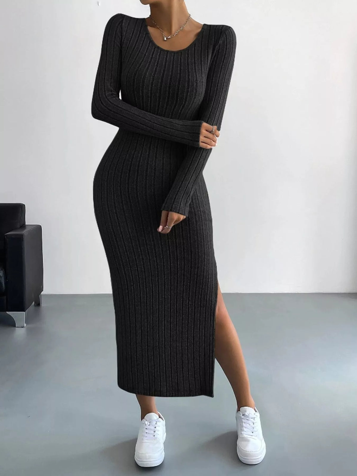 Black ribbed knit long-sleeve midi dress with a high side slit, front view