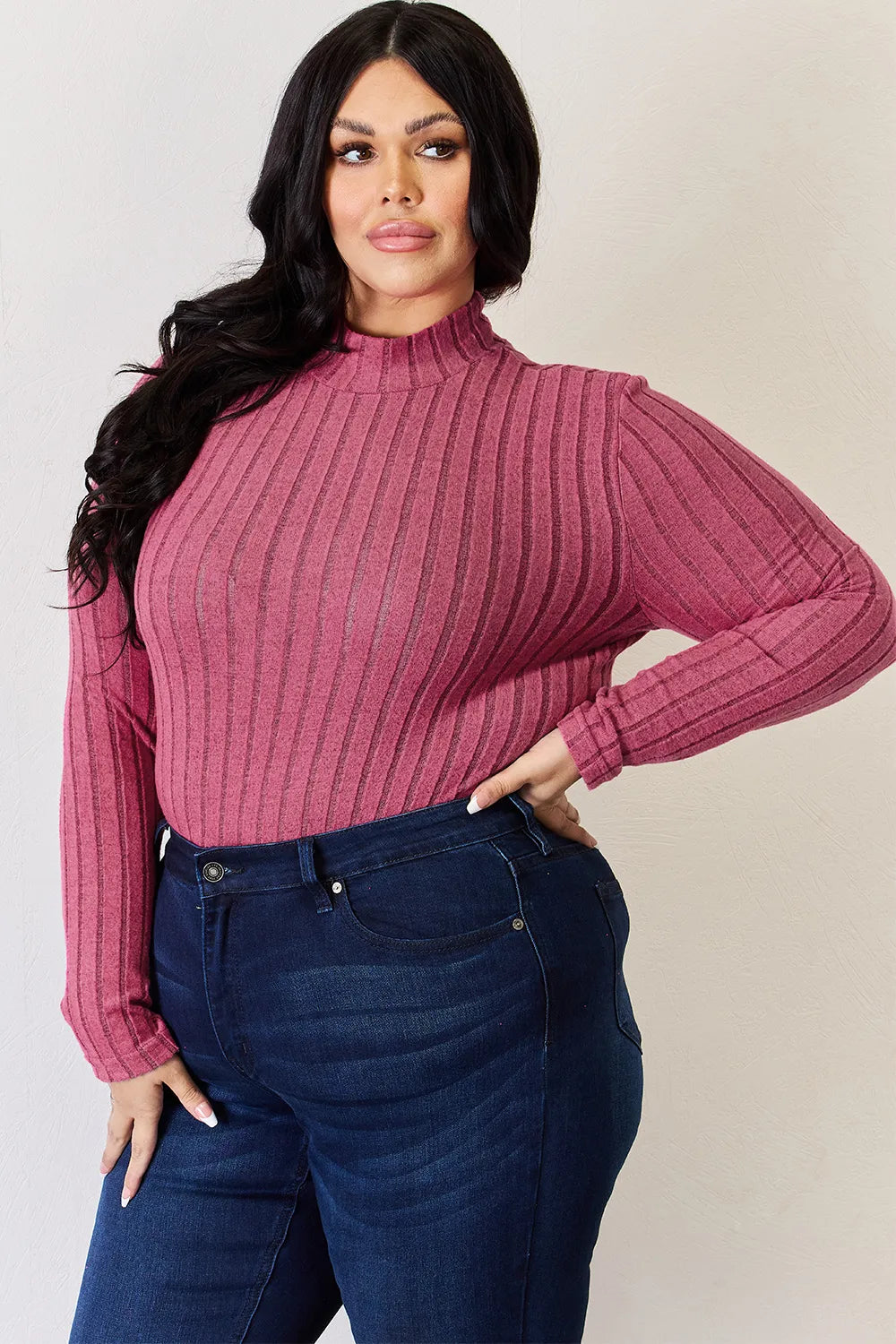 Ribbed mock neck long sleeve tee in Hot Pink, a berry pink, worn tucked into dark jeans