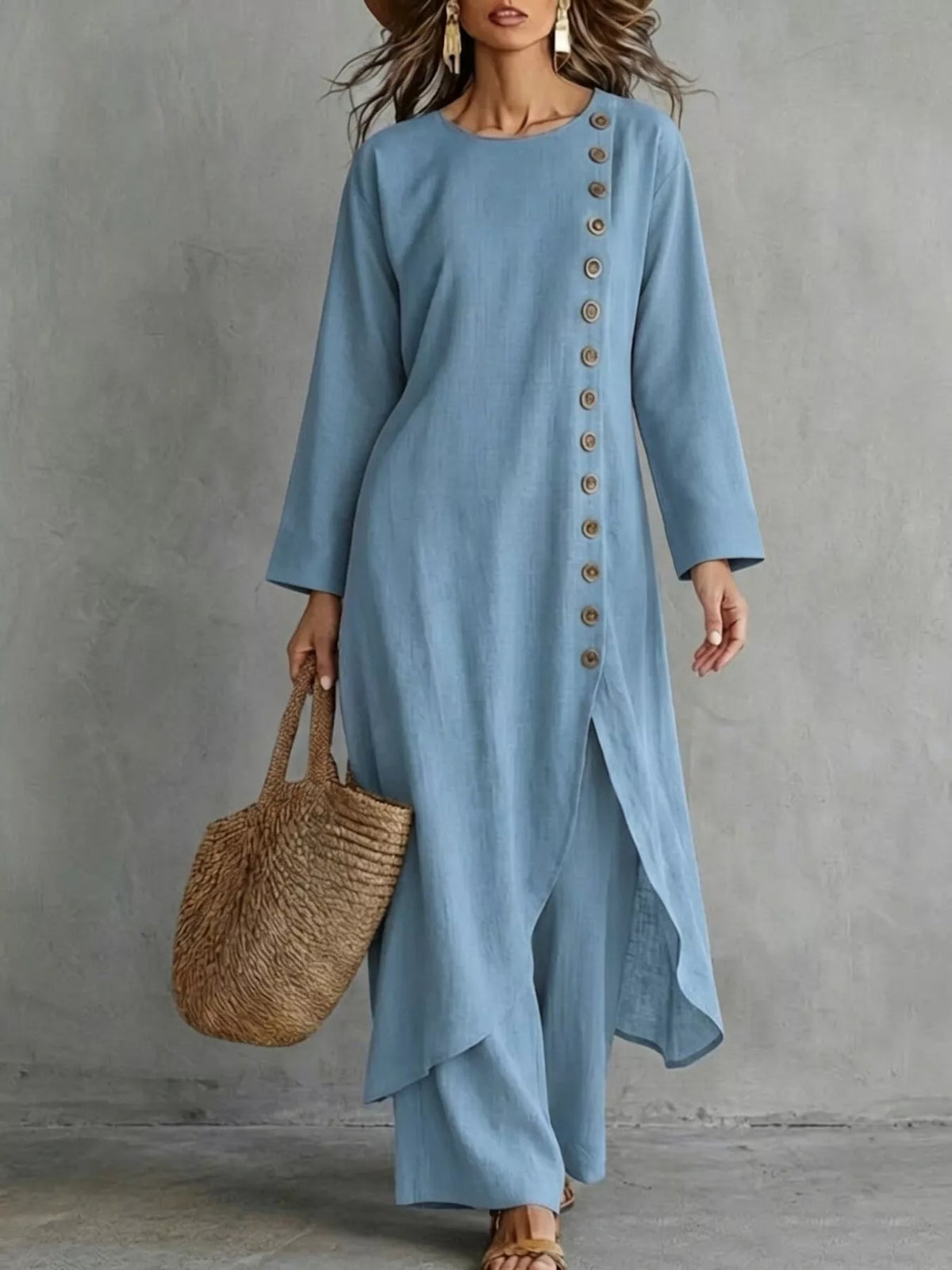 Blue longline top with a row of buttons down one side and matching pants, front view
