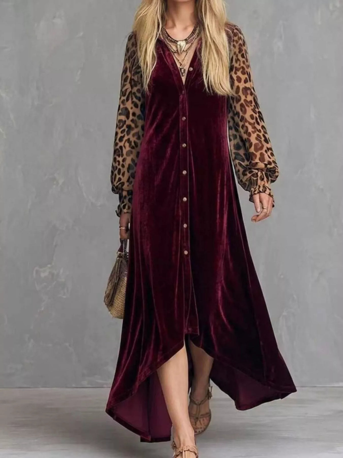 Woman wearing a burgundy velvet button-front maxi dress with leopard print sleeves, full-length front view