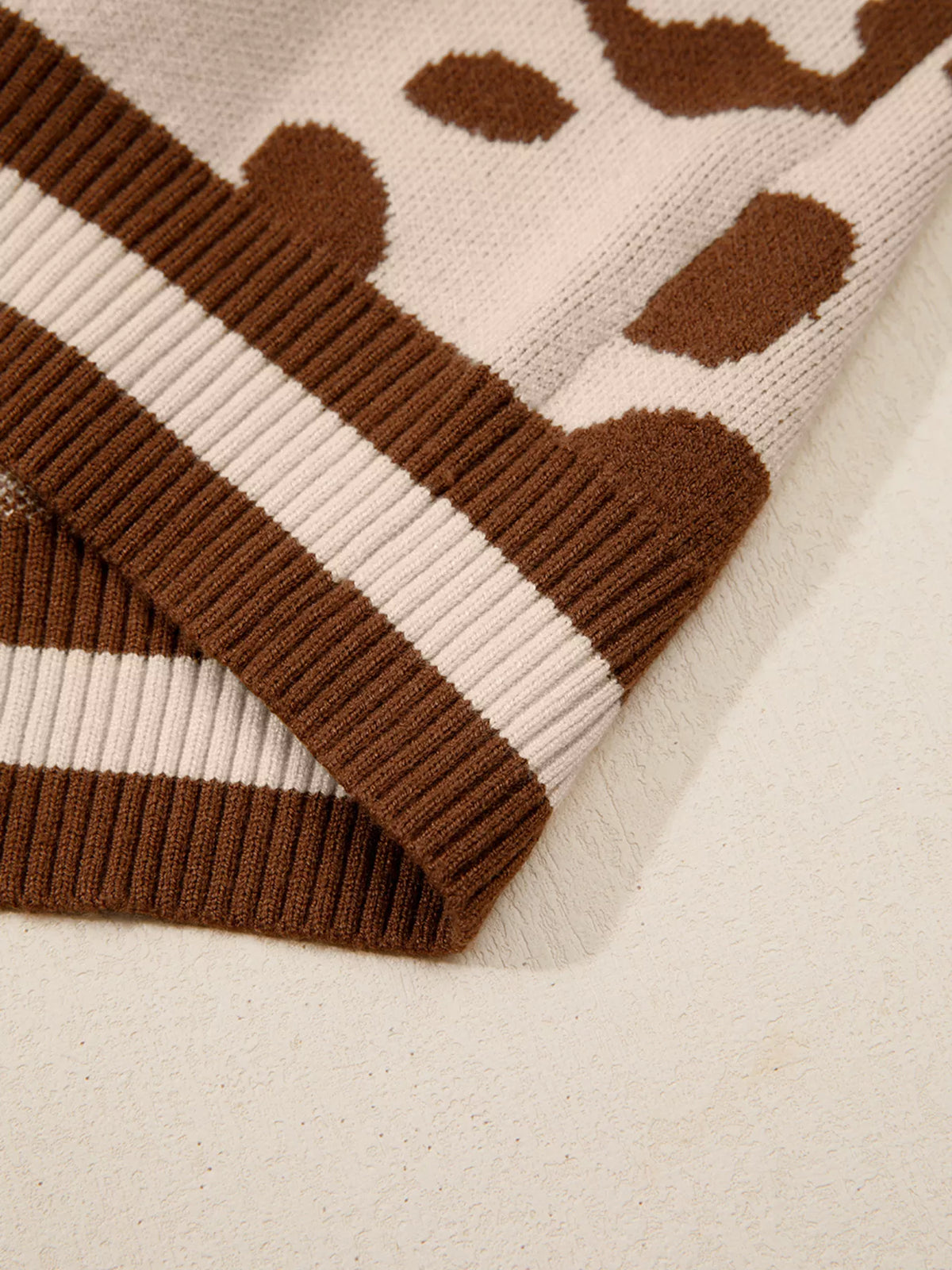 Close-up of the striped rib hem of the leopard print sweater