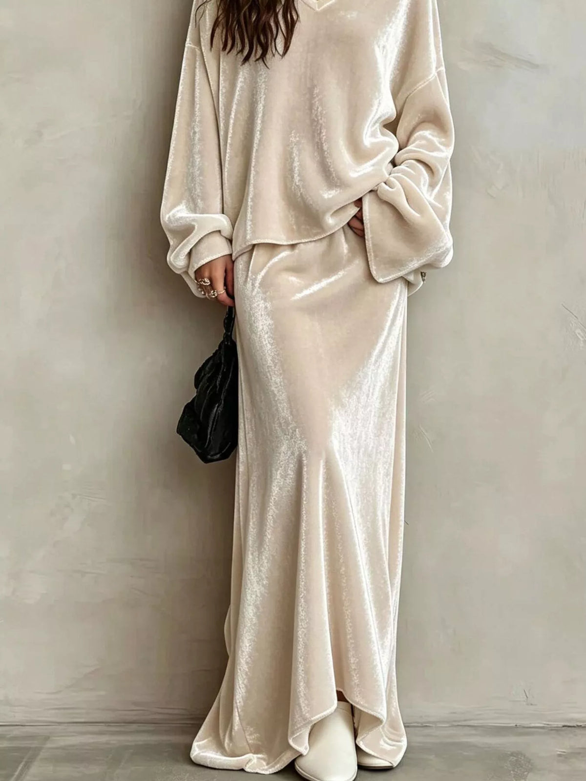 Beige velvet maxi skirt with a flared hem, worn with the matching V-neck top