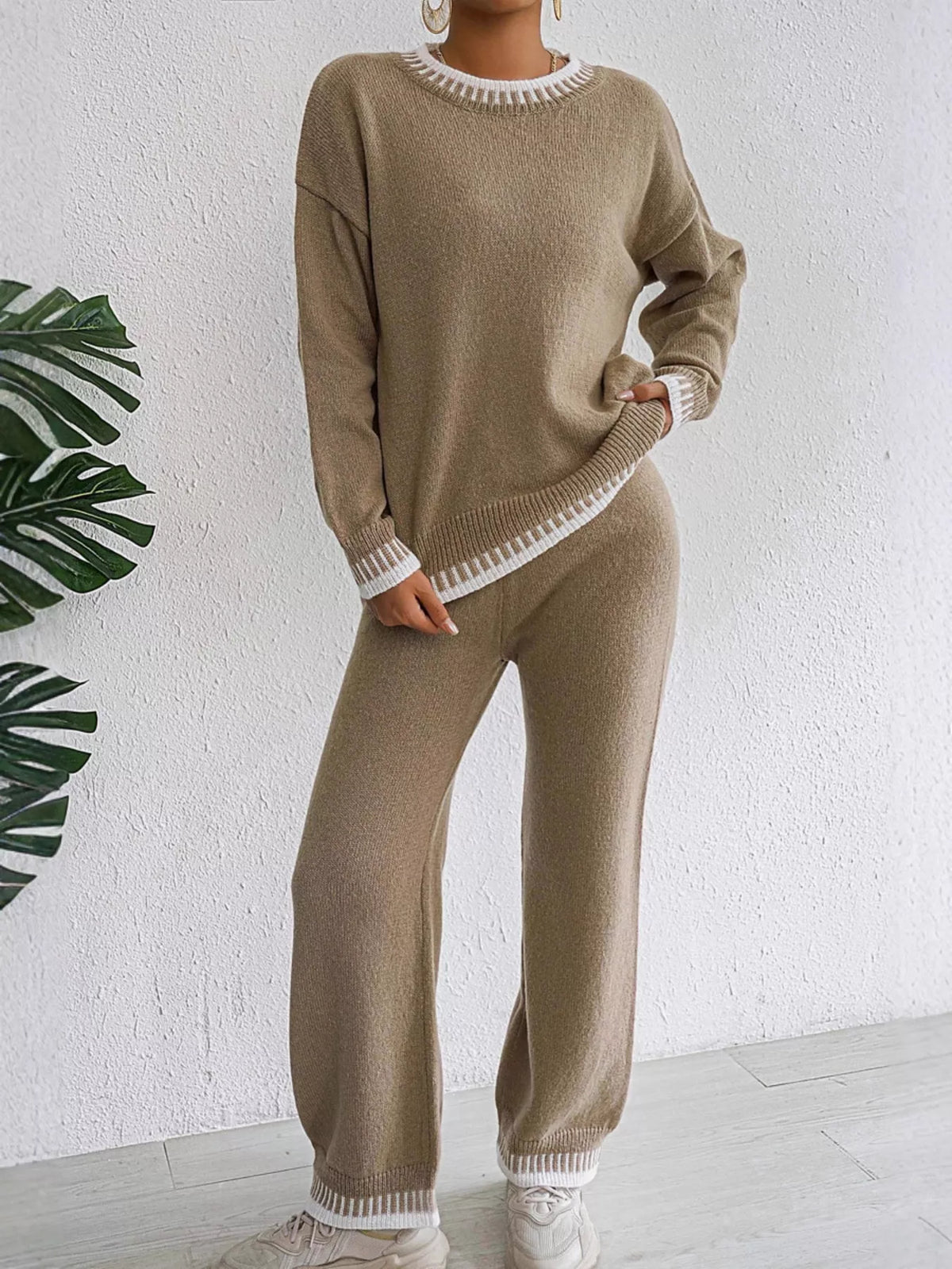 Taupe crew neck knit sweater and knit pants with white contrast stitching at the neckline, cuffs and hems, front view