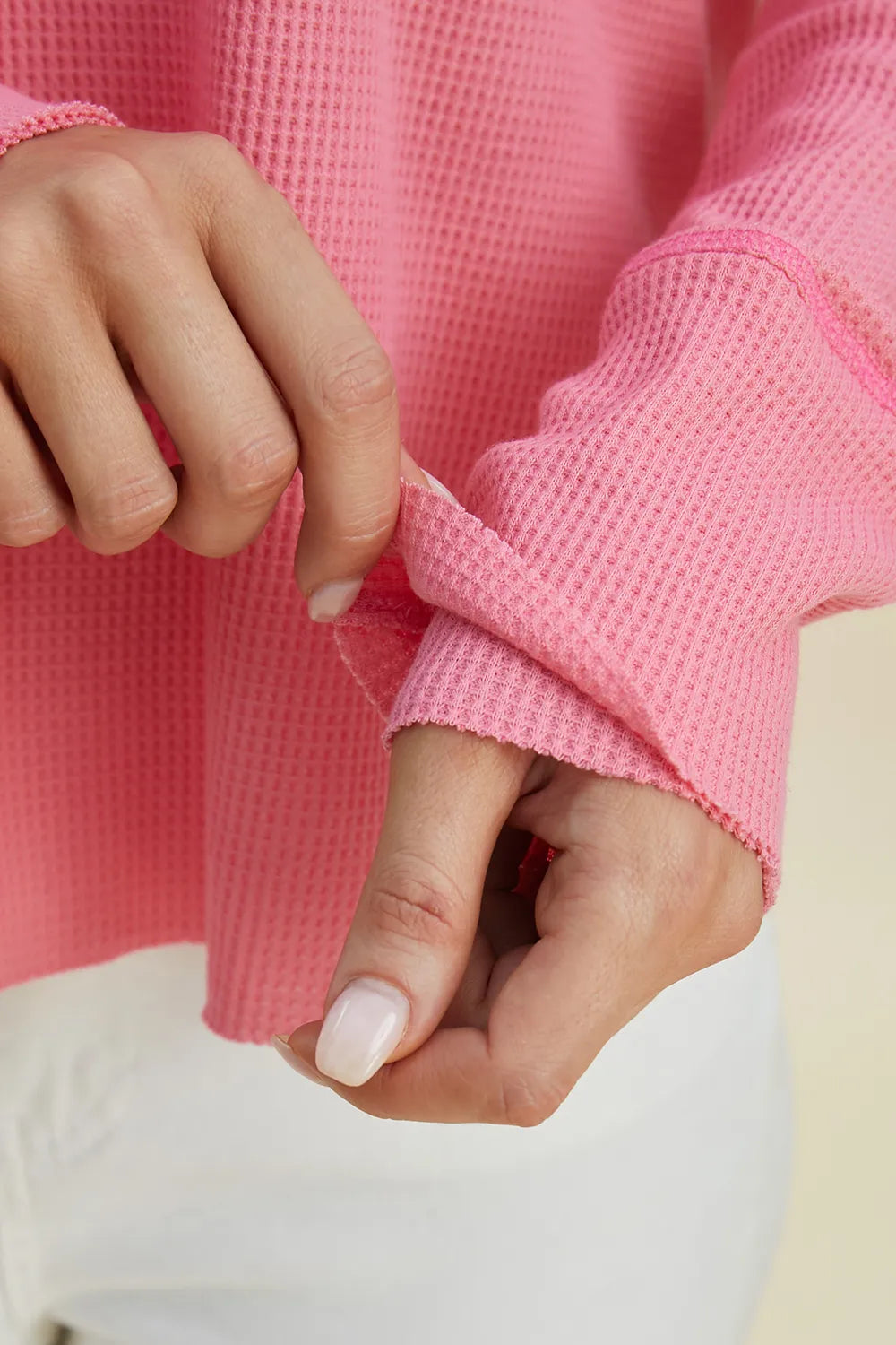 Detail of the pink hoodie cuff and seam stitching