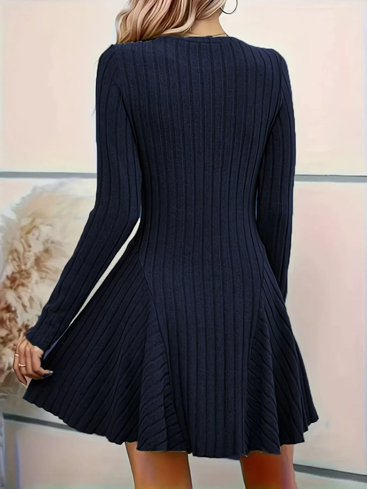Back view of the Navy Blue ribbed knit long-sleeve flared dress with panelled skirt