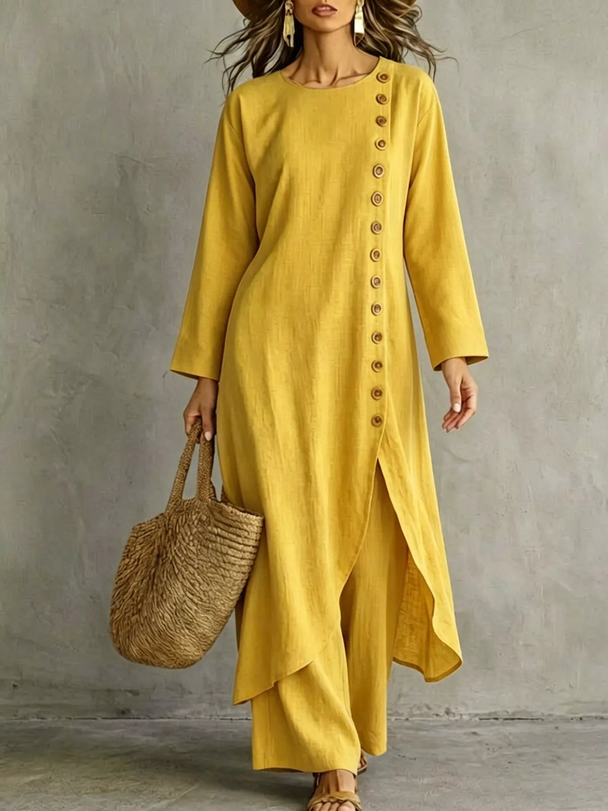 Yellow longline top with a row of buttons down one side and matching pants, front view