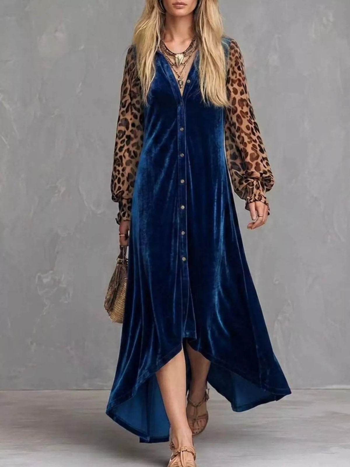 Woman wearing a blue velvet button-front maxi dress with leopard print sleeves, full-length front view