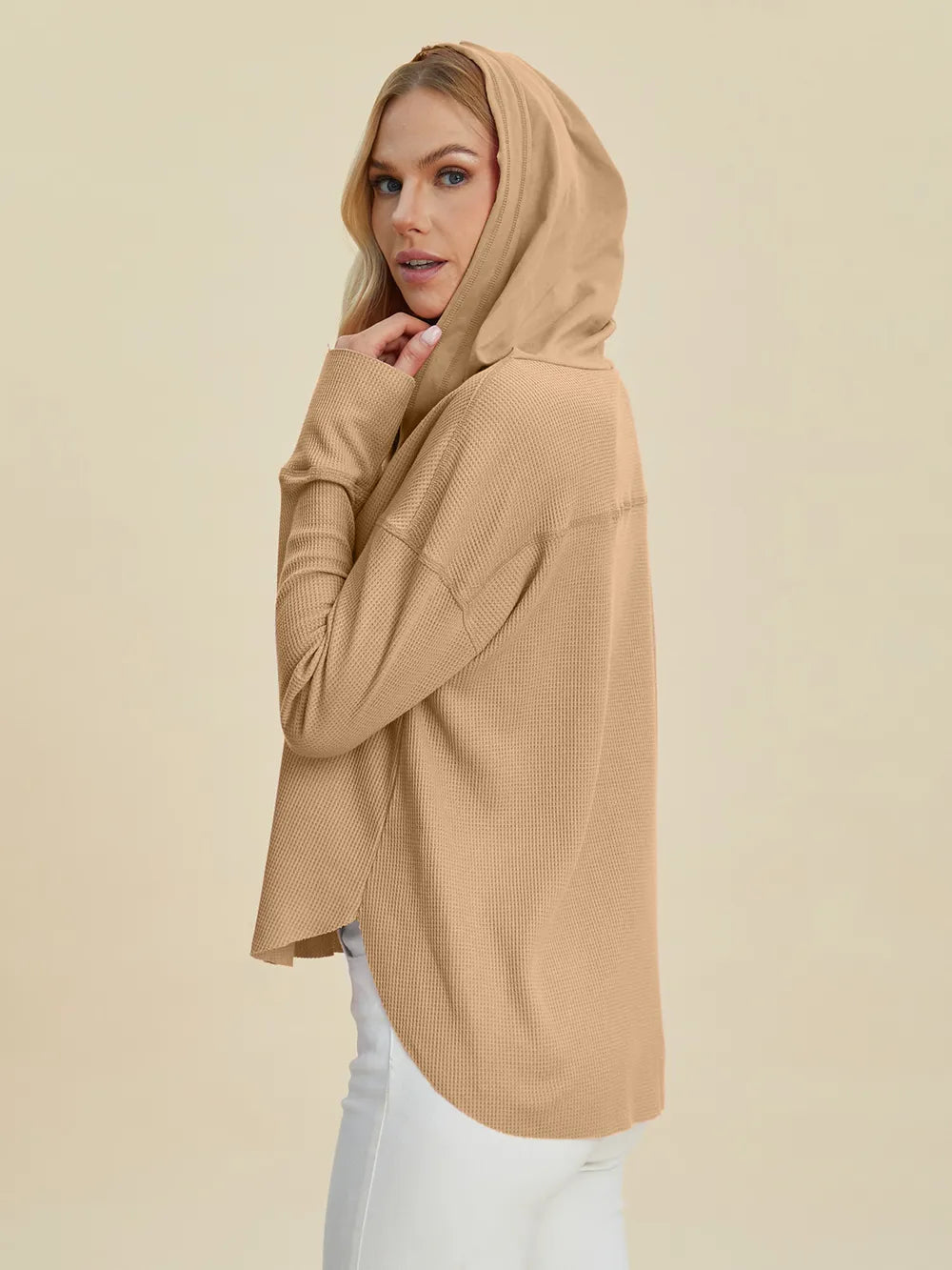 Back view of the camel hoodie showing the hood and high-low hem
