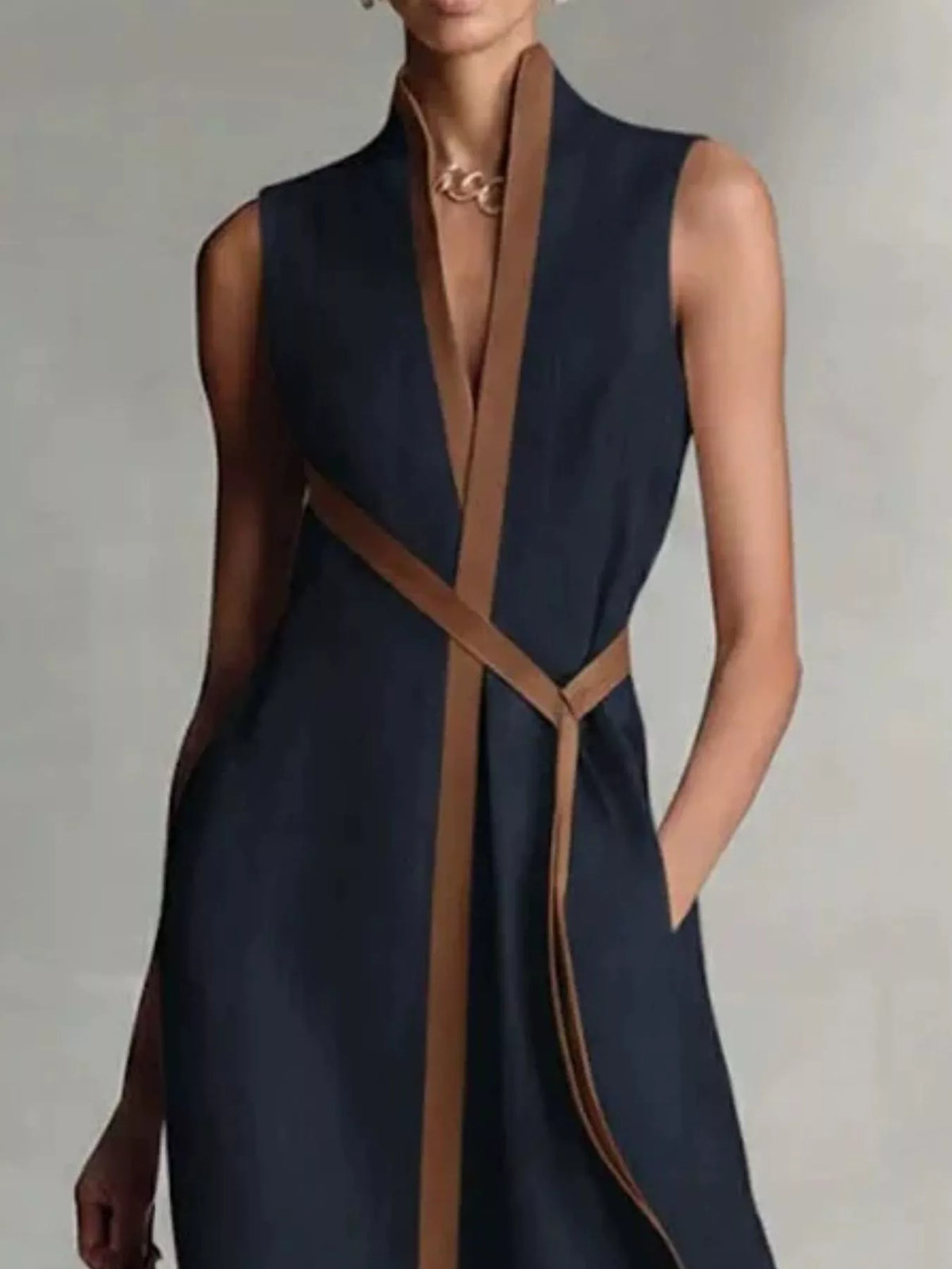 Close view of the Dark Blue wrap maxi dress showing the brown-edged V front, crossed tie belt and side pocket