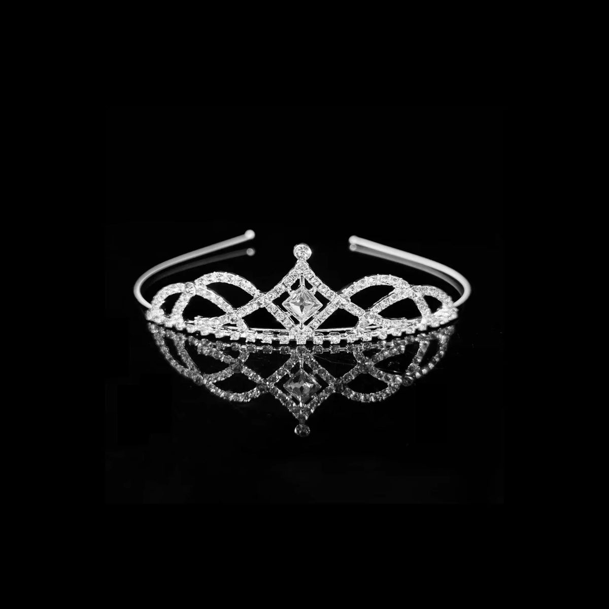 Silver tiara with interlaced looping scrollwork around a diamond-shaped centre crystal