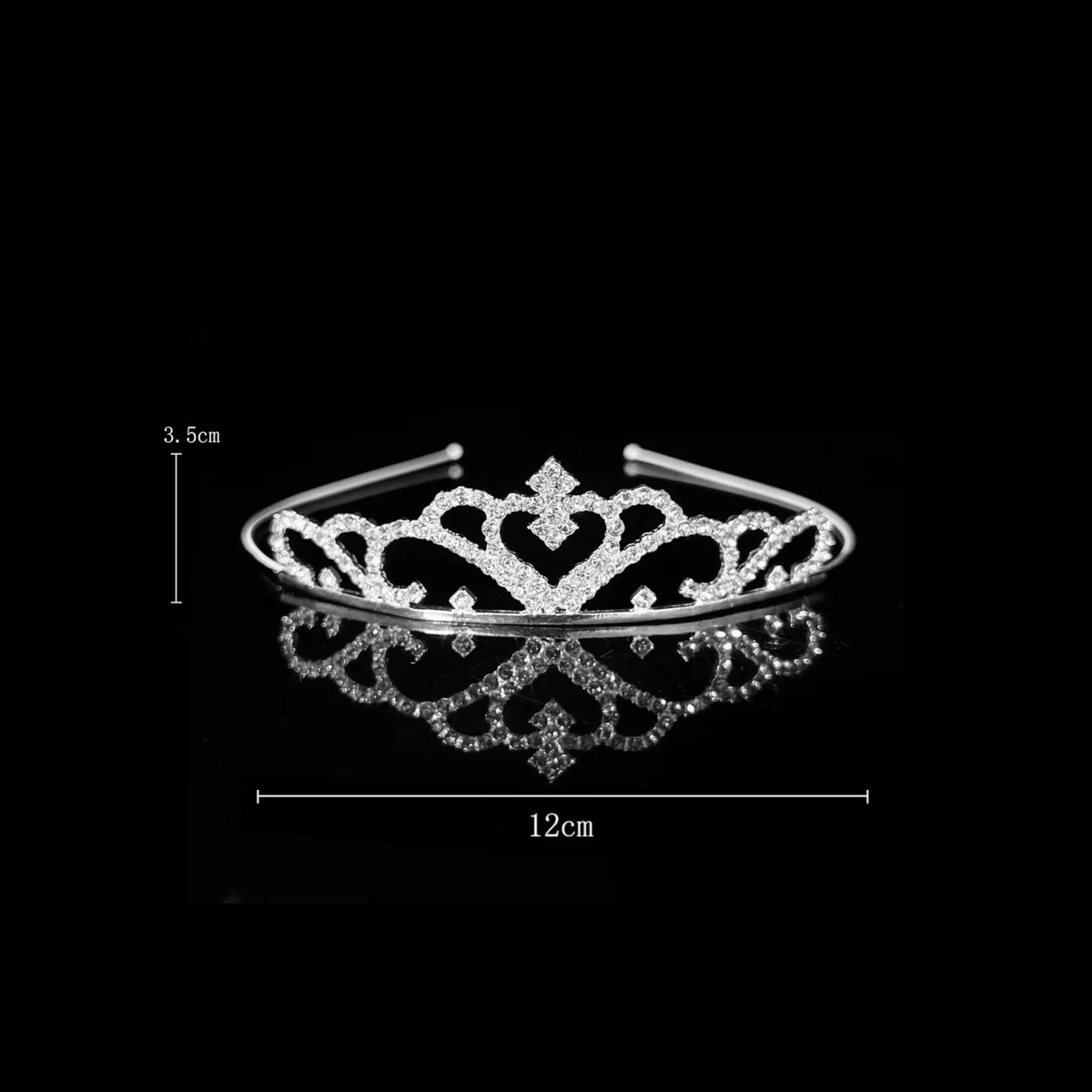 Silver tiara with heart-shaped scrollwork either side of a raised diamond motif — detail