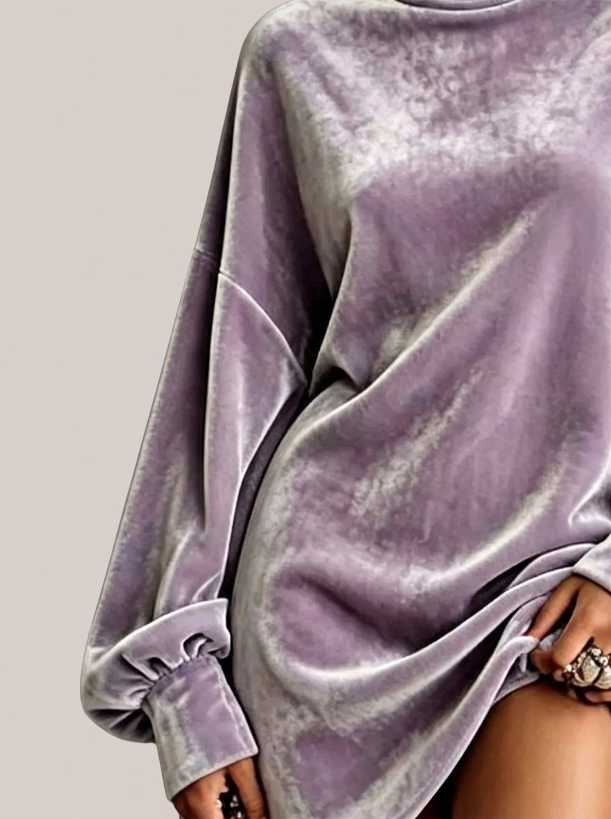 Close-up of the sleeve and velvet fabric of a purple mini dress