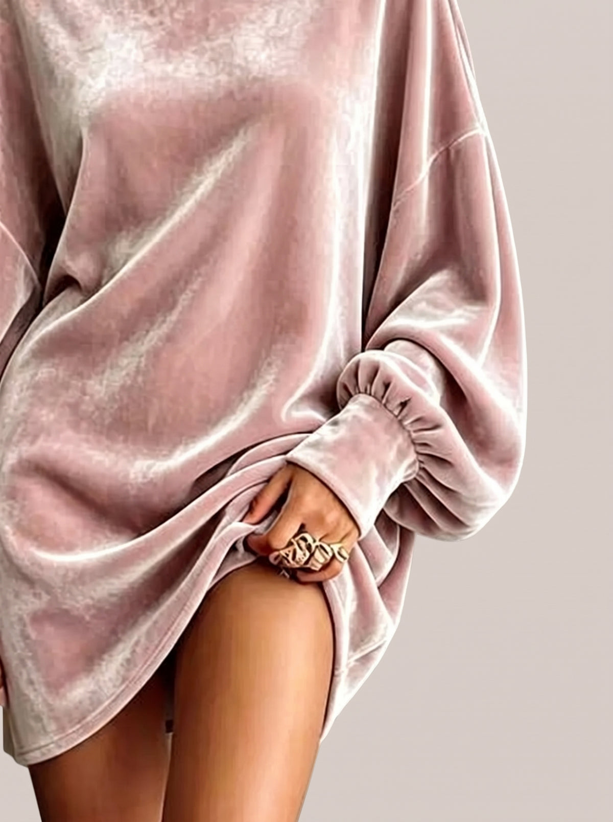 Close-up of the gathered sleeve cuff of a pink velvet mini dress