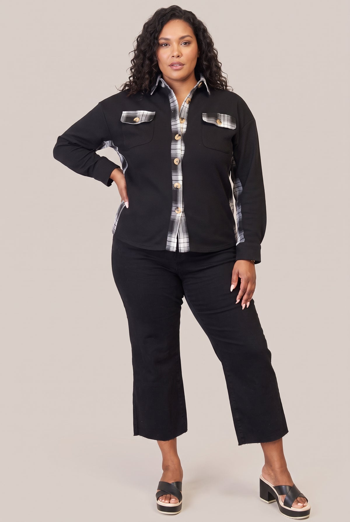 Full-length view of the black plaid-trim jacket