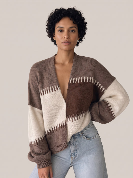 Brown, taupe and cream colour-block knit cardigan with a deep V-neck and jagged white and brown stitched stripe edges, worn open at the front (Brown option)