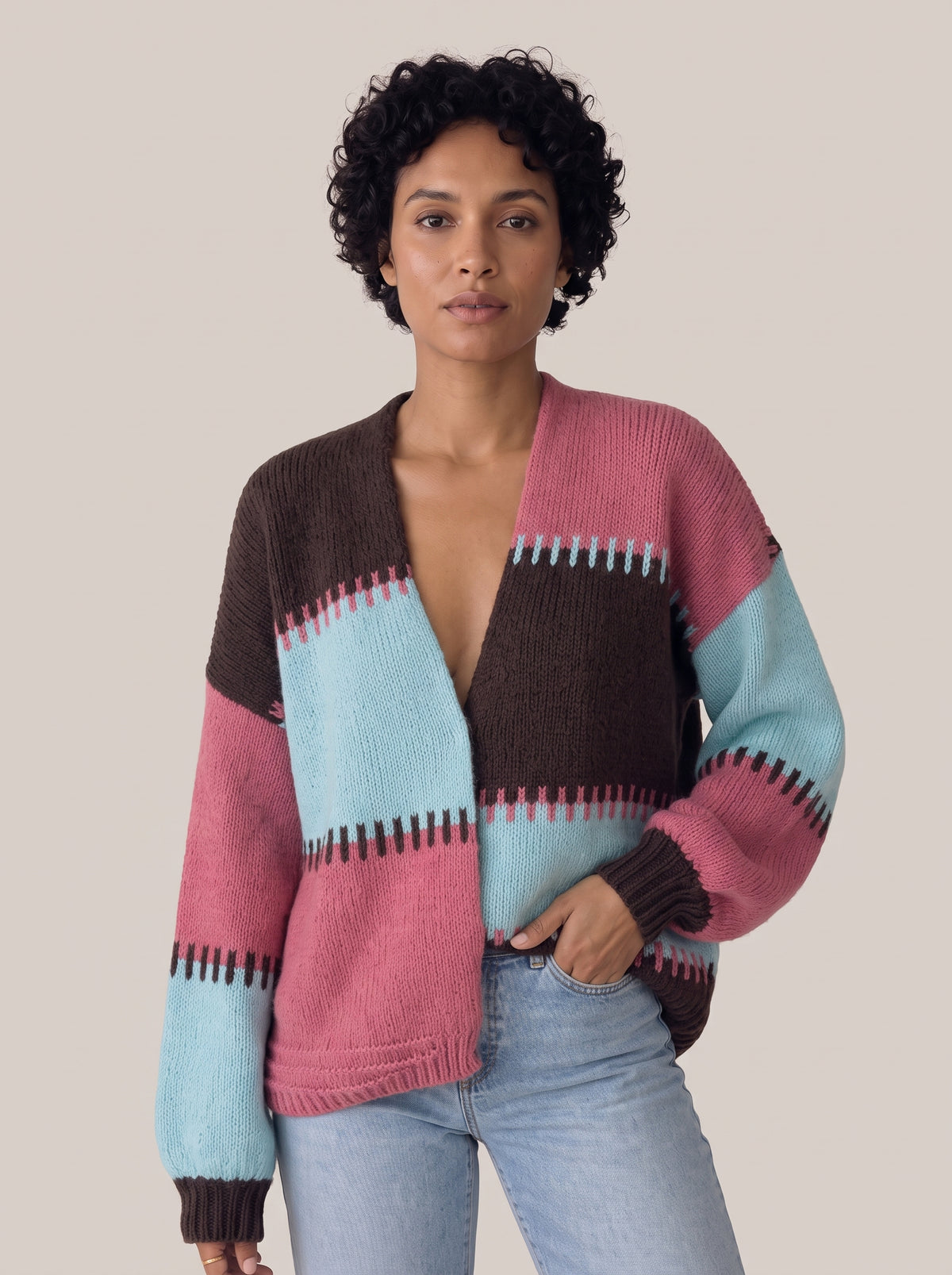 Pink, aqua and dark brown colour-block knit cardigan with a deep V-neck, jagged stitched stripe edges and balloon sleeves, front view (Pastel Blue option)