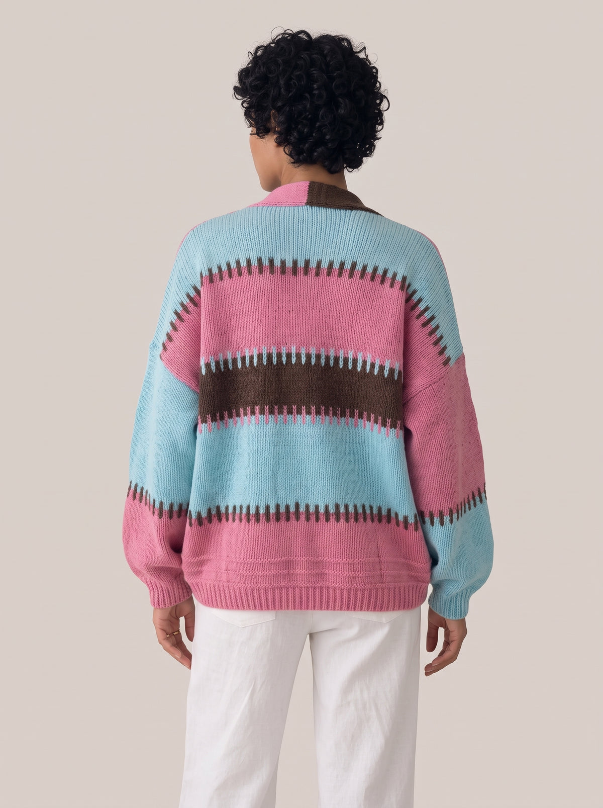 Back view of the pink, aqua and dark brown striped knit cardigan with a ribbed hem and balloon sleeves (Pastel Blue option)