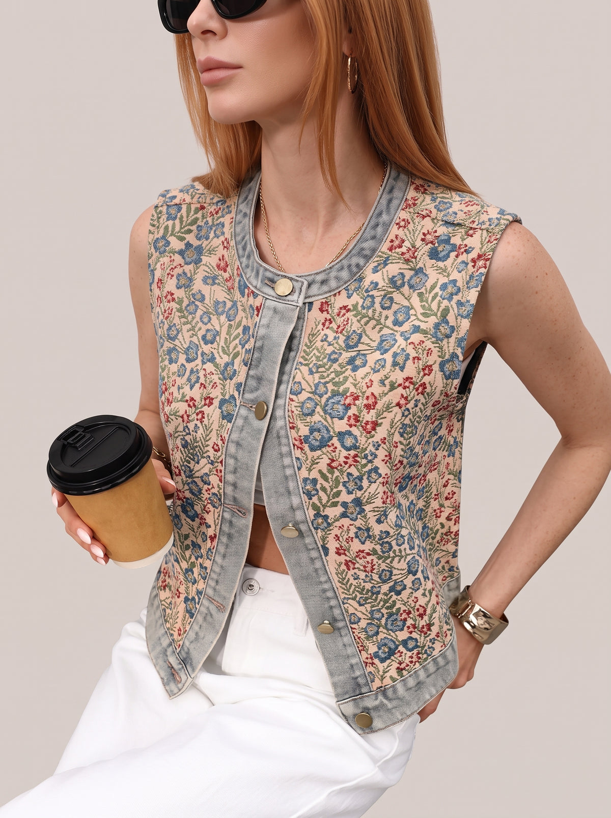 Floral vest top worn open, front view with a coffee cup