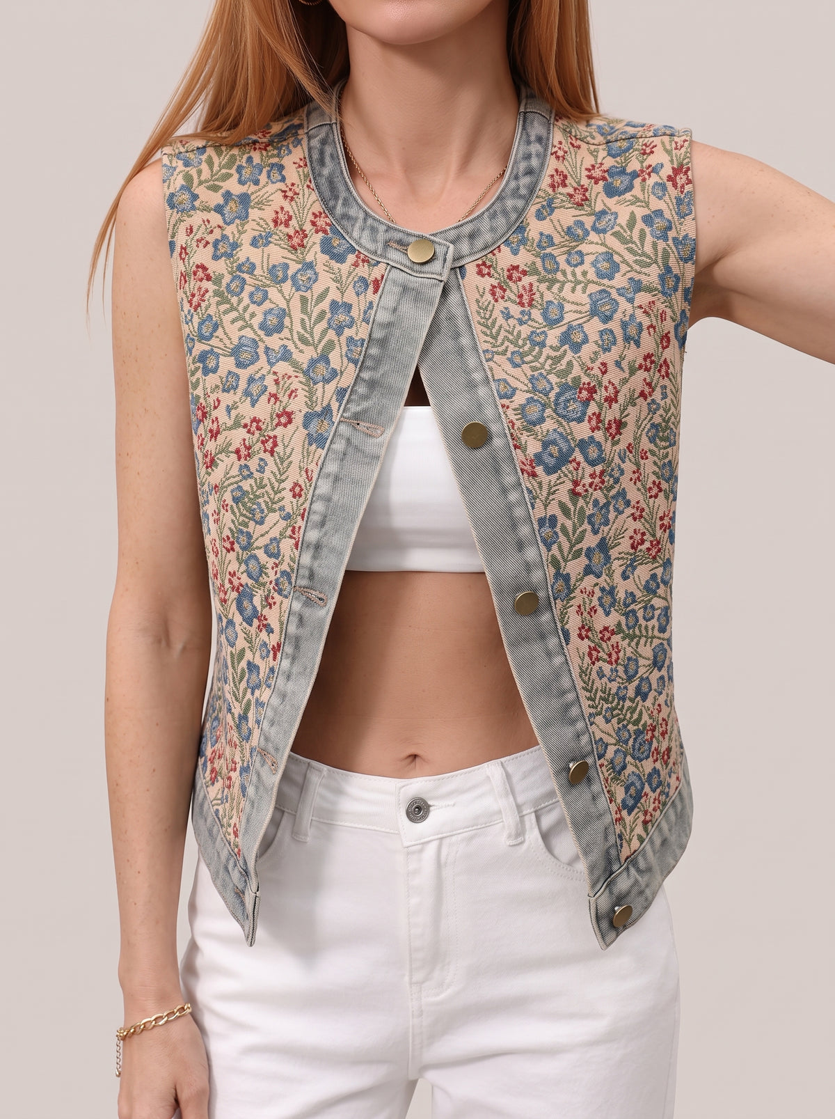 Close view of the floral vest top worn open, showing the pattern and denim trim