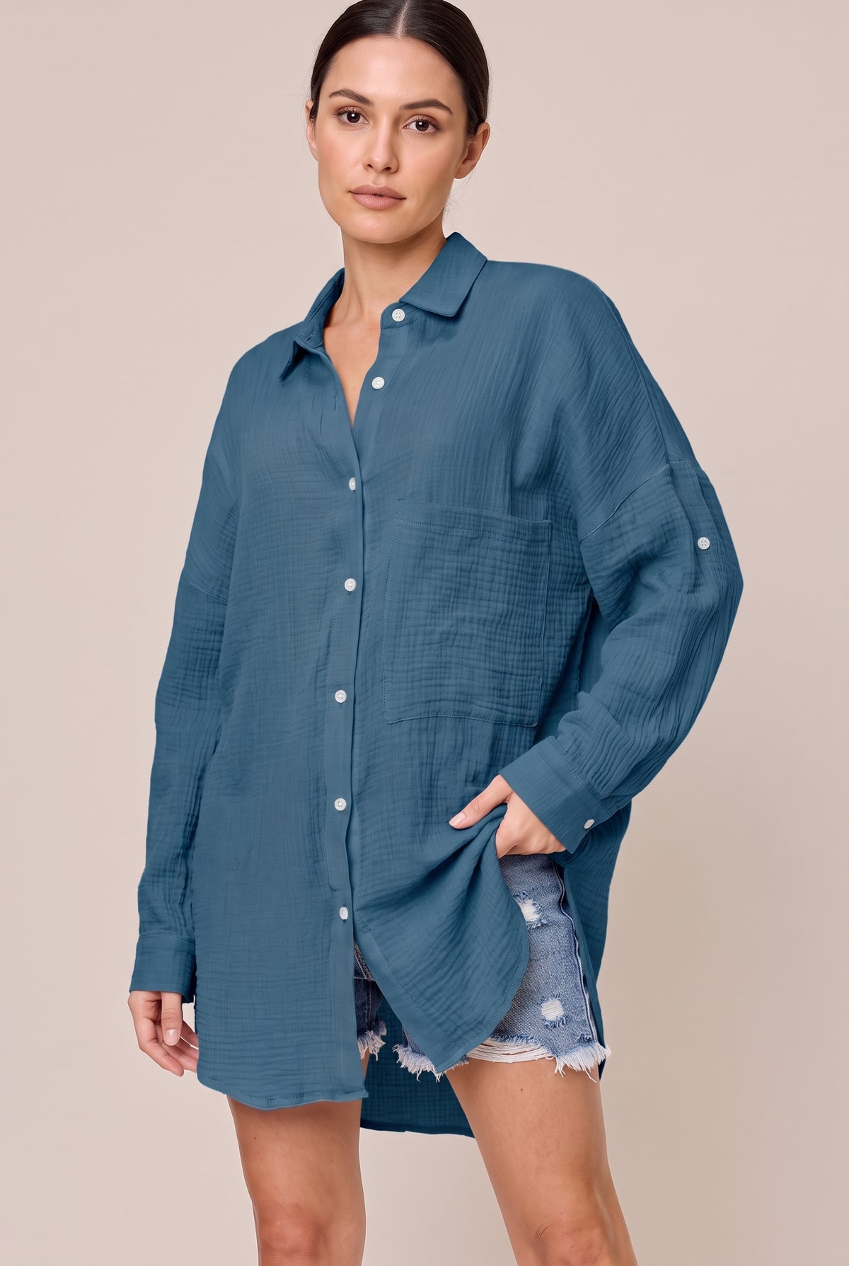 Dark Blue textured button-up shirt worn loose over denim shorts, showing the chest pocket and curved hem