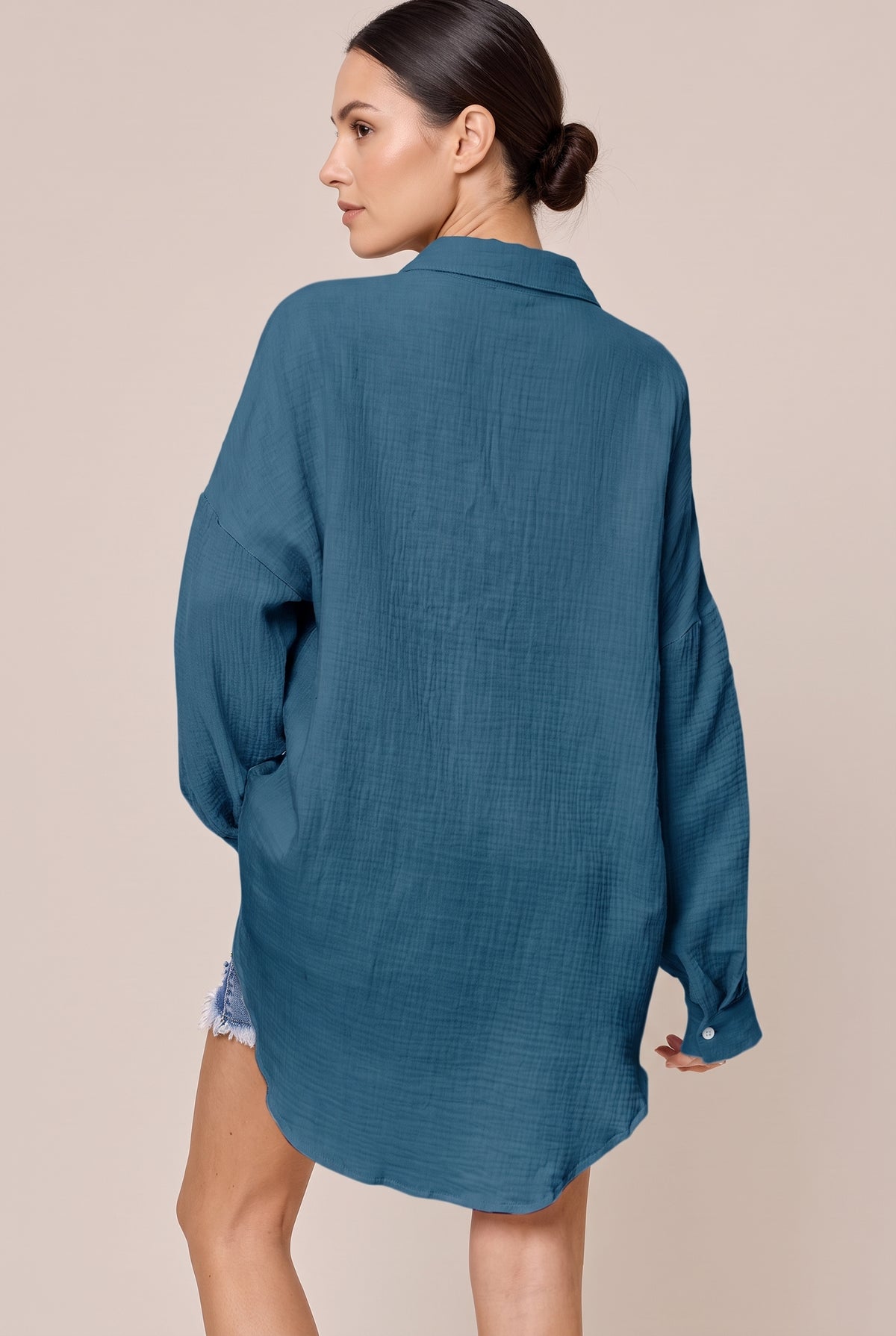 Back view of the Dark Blue textured button-up shirt with dropped shoulders and a curved high-low hem