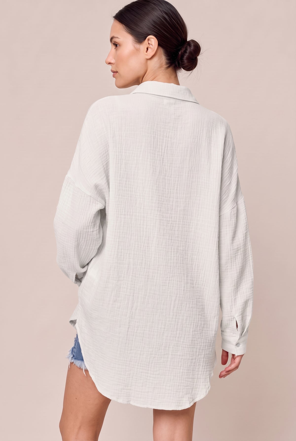 Back view of the White textured button-up shirt with a curved high-low hem