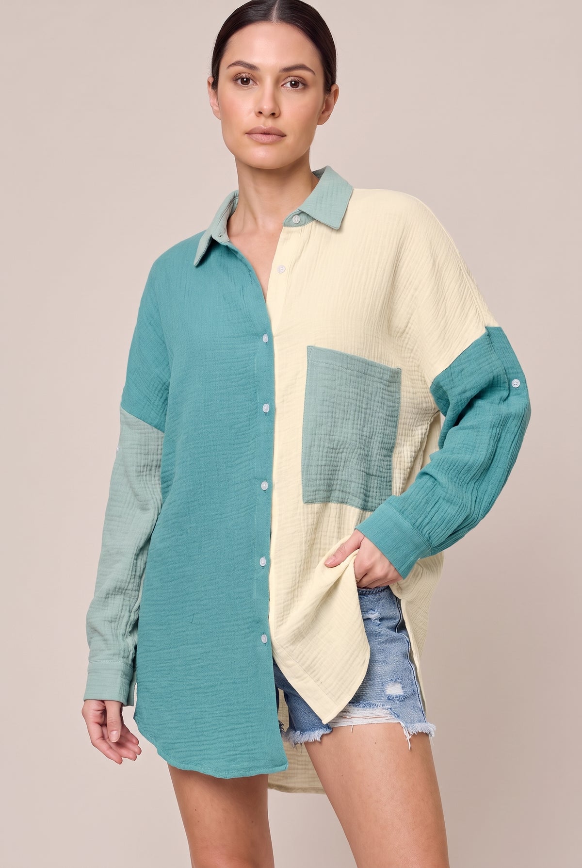 Teal color-block button-up shirt with teal and cream front panels and a pale sage collar and pocket, front view