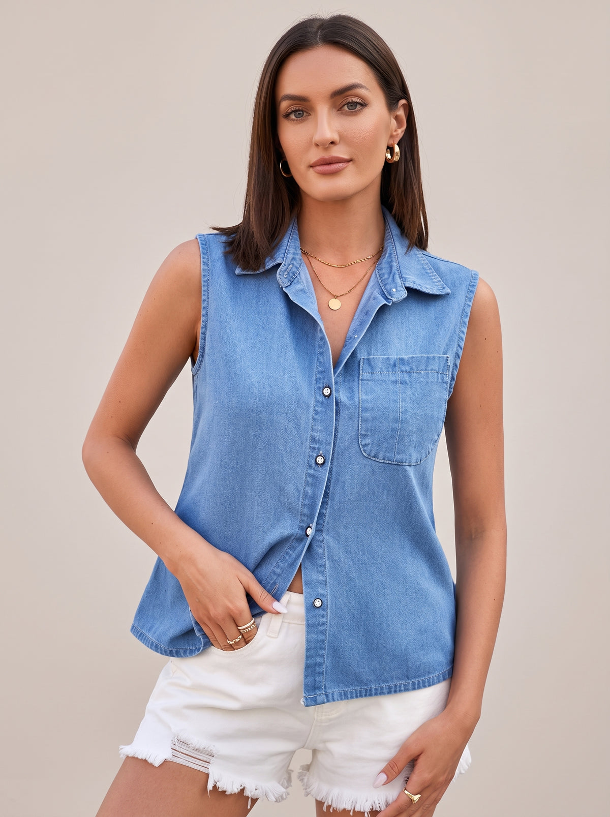 Light blue sleeveless denim top, front view with pointed collar, button front and chest pocket