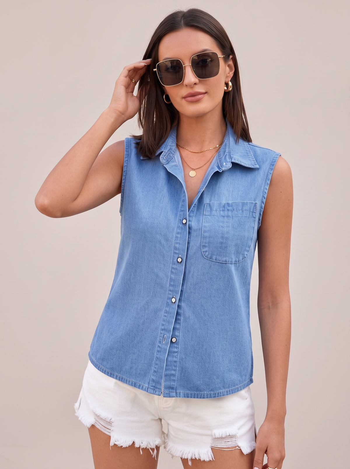 Light blue sleeveless denim top worn with sunglasses, front view