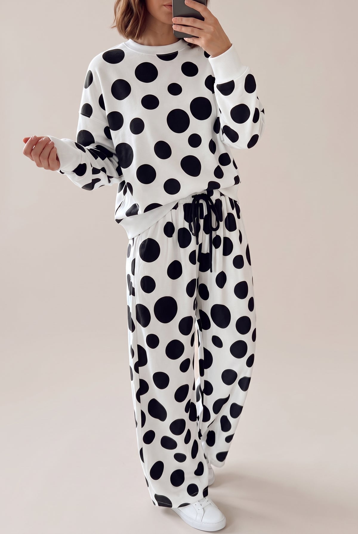 Black and white polka dot long sleeve top and matching wide-leg drawstring pants, full-length front view